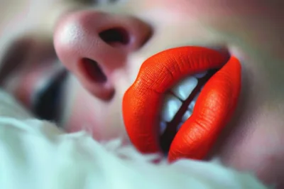 Close Up Of Woman With Bright Orange Lipstick