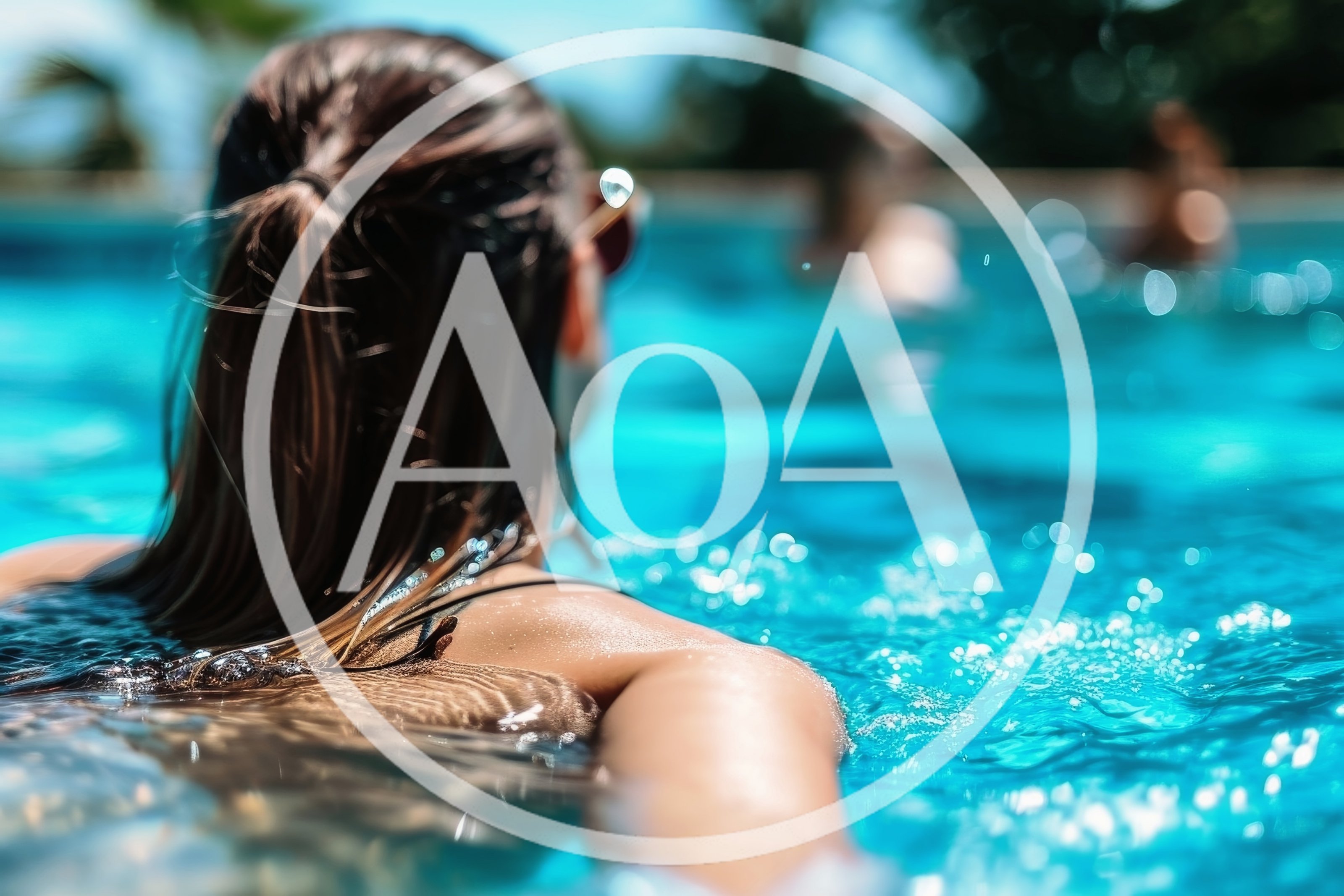 Woman Relaxing In A Sunny Swimming Pool