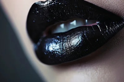 Close Up Of Woman Wearing Glossy Black Lipstick