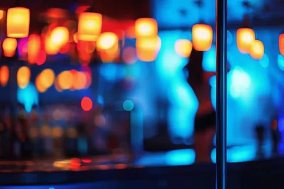 Blurred Nightclub Interior With Pole Dancer Silhouette