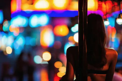 Woman Standing By Pole In Neon Nightclub