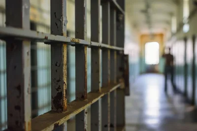 Prison Cell Bars In A Dimly Lit Corridor