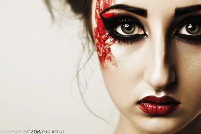 Close Up Portrait Of Woman With Artistic Red Makeup