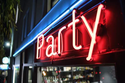 Neon Party Sign Glowing Above A Nightclub Entrance