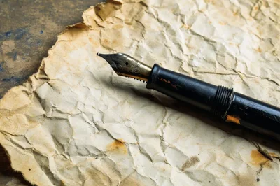 Vintage Fountain Pen Resting On Crumpled Aged Paper