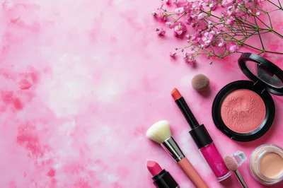 Flat Lay Makeup Collection With Pink Flowers