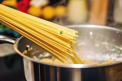 Spaghetti Pasta Being Added To Boiling Water