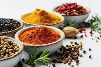 Assorted Spices and Peppercorns in Ceramic Bowls