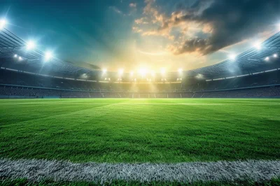 Empty Football Stadium Pitch Under Dramatic Sunset Sky