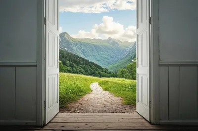 Open Doorway Revealing A Scenic Mountain Landscape