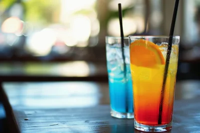 Two Refreshing Cocktails On A Wooden Table
