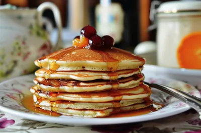 Stack Of Fluffy Pancakes With Syrup And Berries