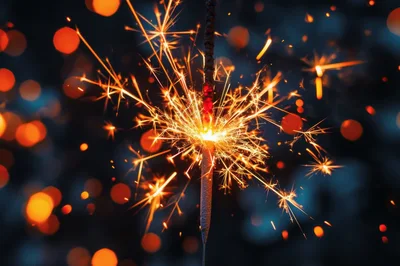 Bright Sparkler Burning Against Dark Blurred Background
