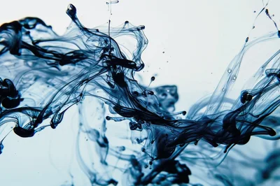 Dark Blue Ink Swirling In Clear Water