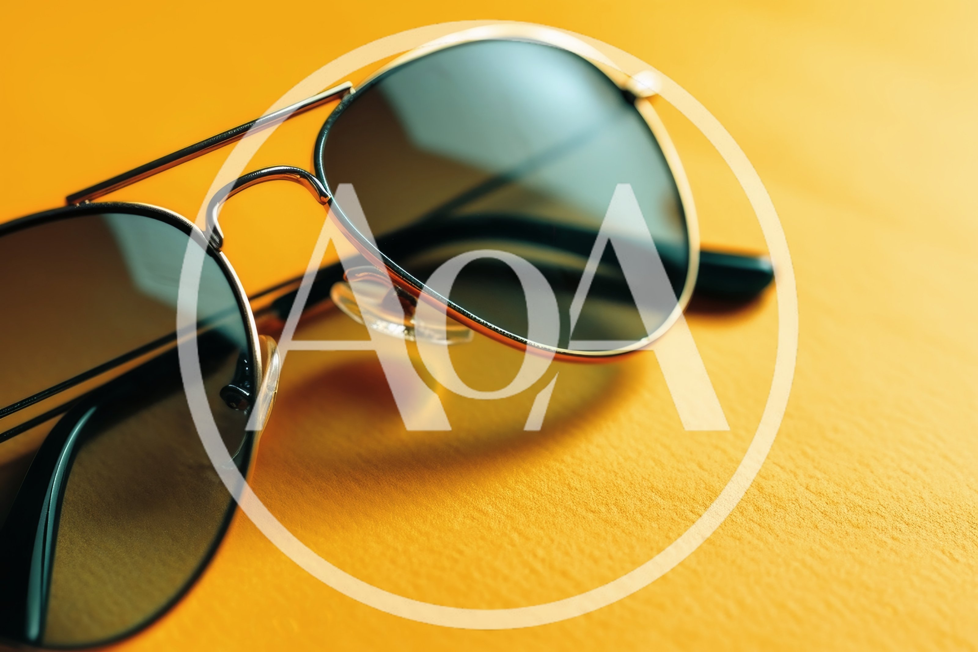 Aviator Sunglasses Resting On A Vibrant Yellow Surface