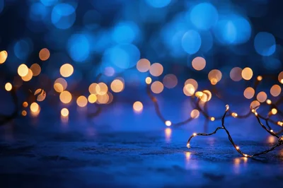 Golden Fairy Lights Against A Deep Blue Bokeh Background