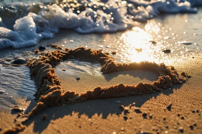 Heart Shape Drawn In Sand On Beach At Sunset