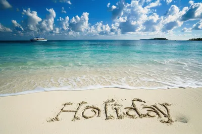 Holiday Written In The Sand On A Tropical Beach