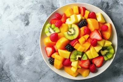 Fresh Fruit Salad Bowl on Textured Gray Background