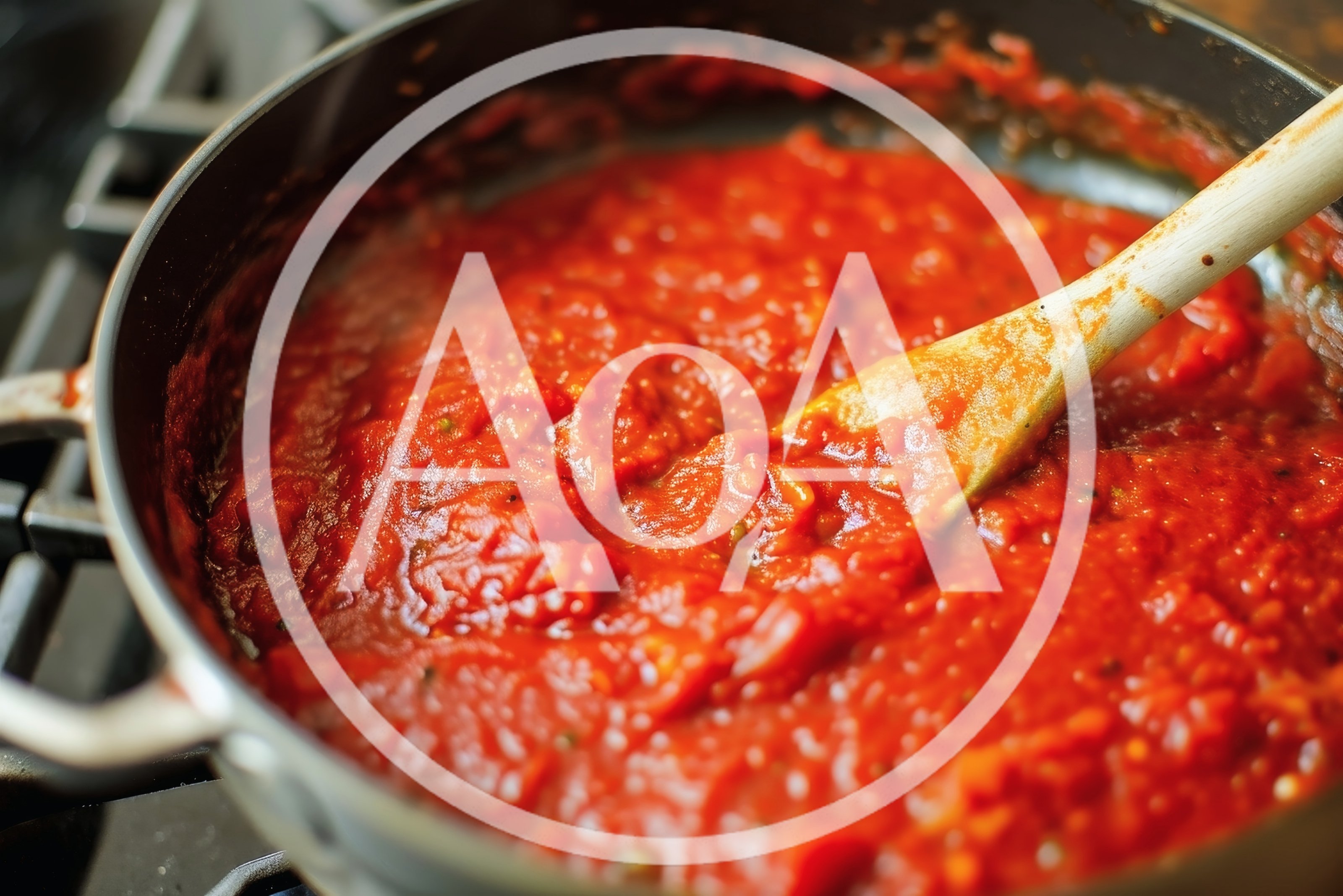 Wooden Spoon Stirring Tomato Sauce In A Pan