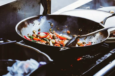 Stir Frying Fresh Vegetables In A Large Wok