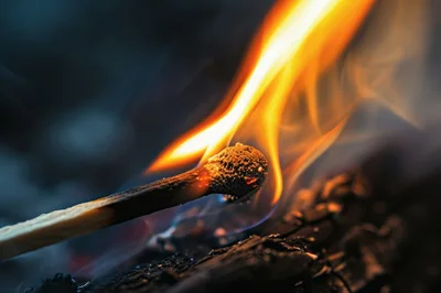 Matchstick Igniting A Piece Of Charcoal