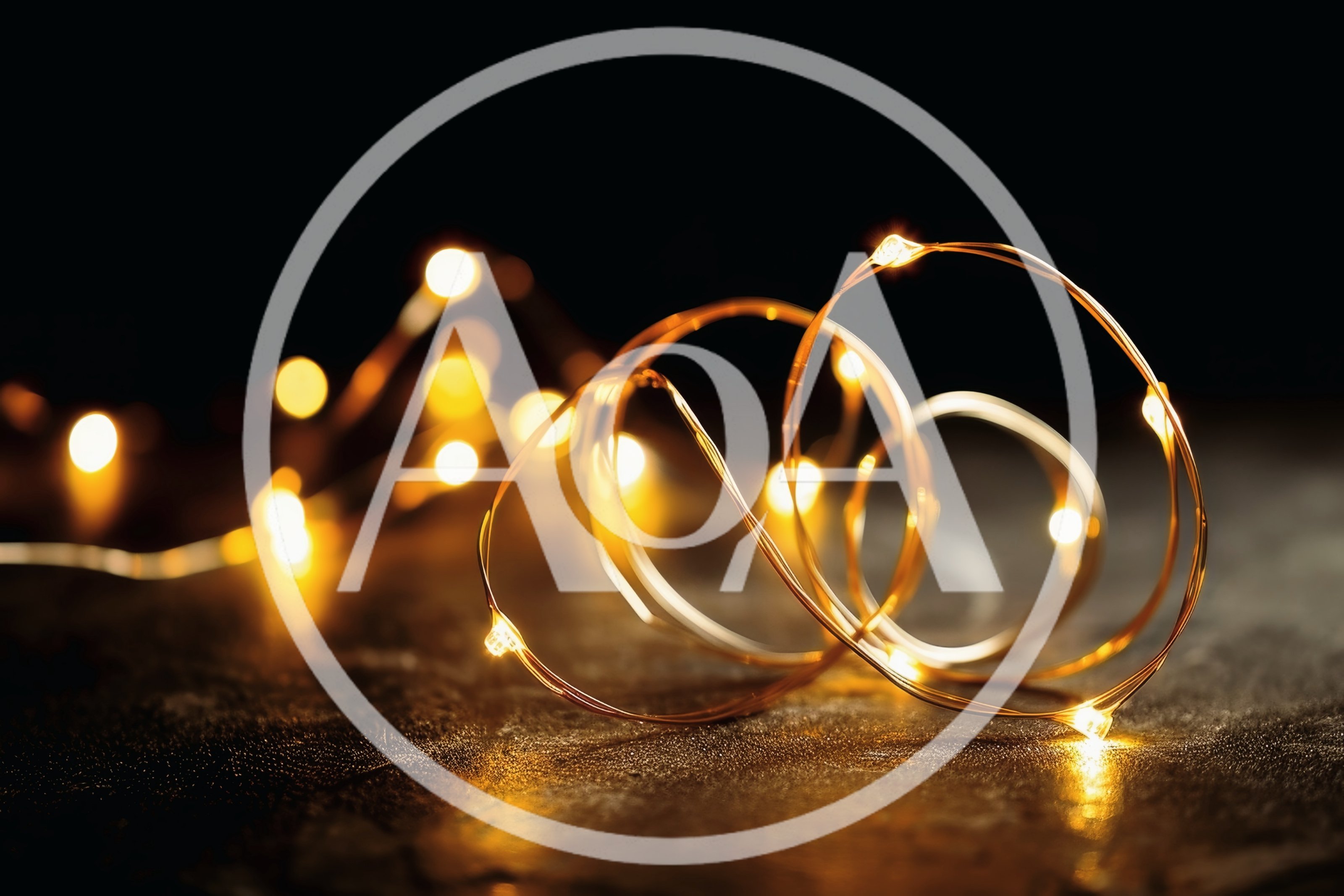 Glowing Fairy Lights Coiled on Dark Textured Surface