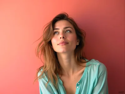 Young Woman Looking Upwards Against Coral Background