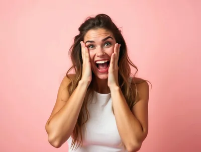 Excited Young Woman With Hands On Cheeks