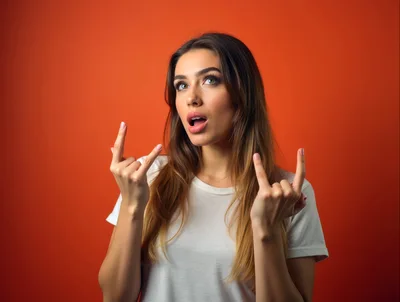 Young Woman Making Rock And Roll Hand Signs