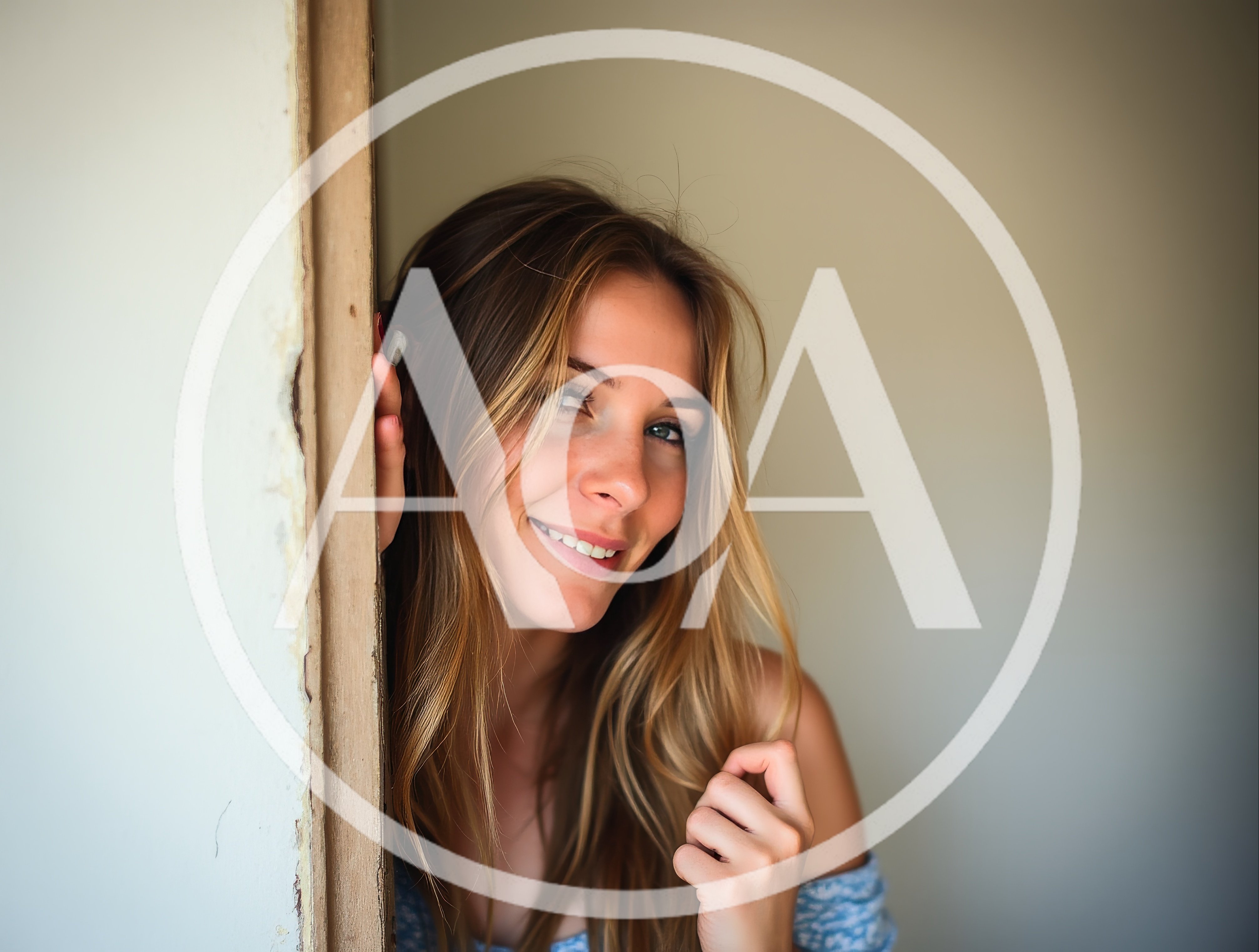 Young Woman Peeking Around A Doorway