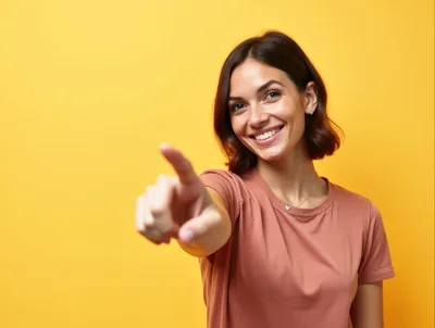 Smiling Young Woman Pointing Directly At Camera