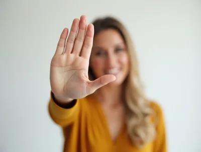 Woman Holding Up Hand In A Stop Gesture