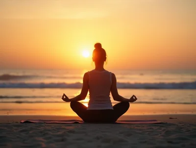 Woman Practicing Yoga Meditation On Beach At Sunset