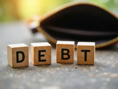 Wooden Blocks Spelling Debt With An Empty Wallet