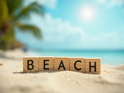 Wooden Blocks Spelling Beach on Tropical Sand