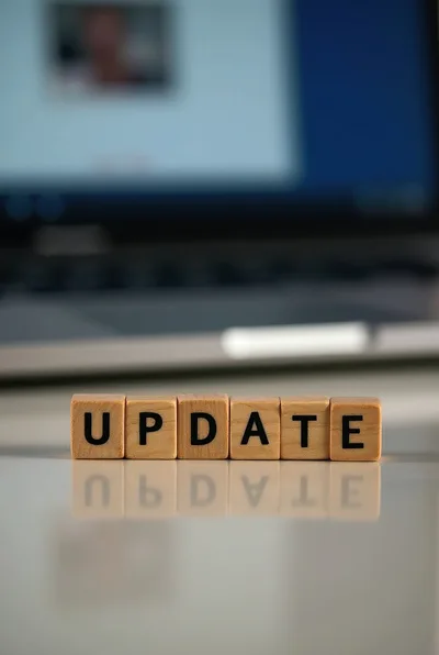 Wooden Blocks Spelling Update In Front Of Laptop