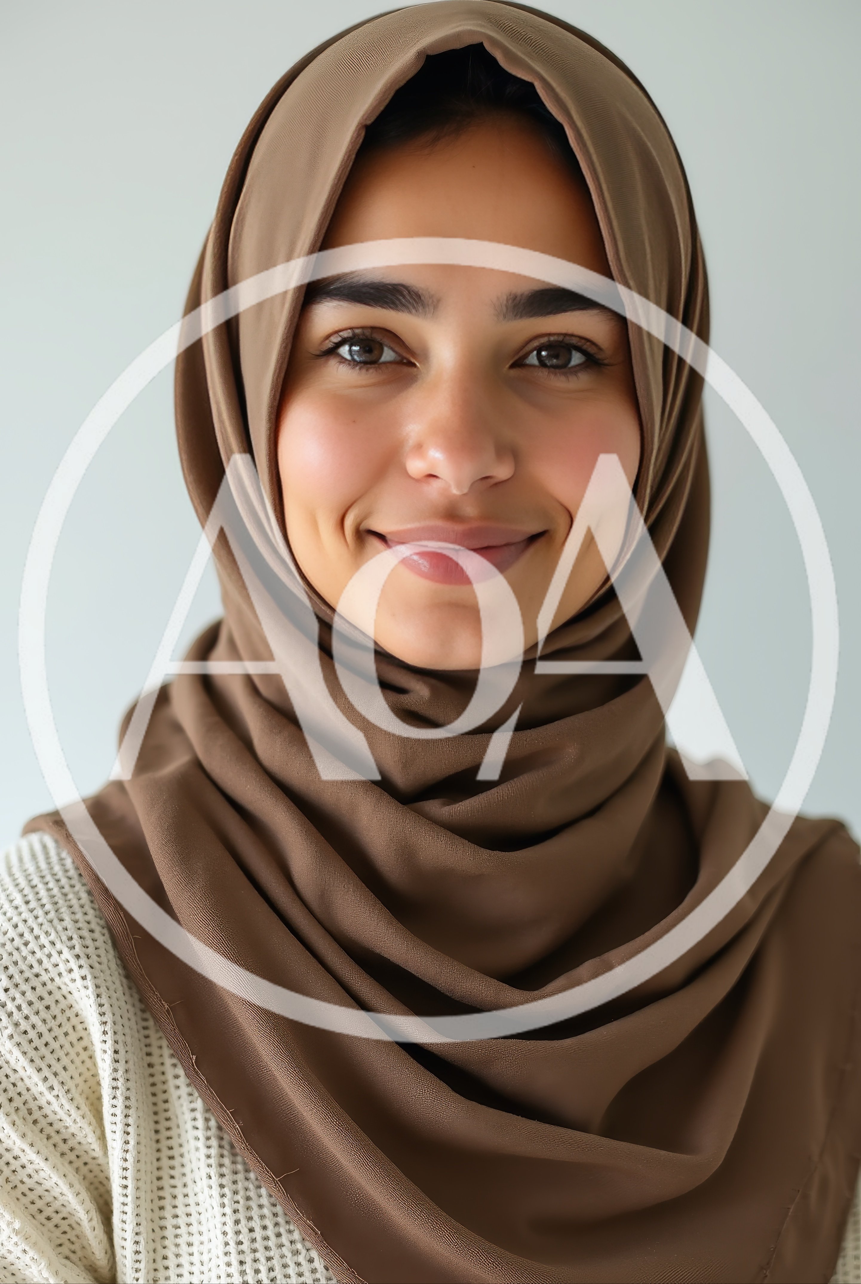 Portrait Of A Smiling Woman Wearing A Brown Hijab