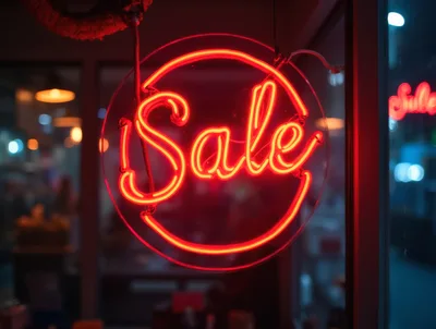 Glowing Red Neon Sale Sign In Store Window