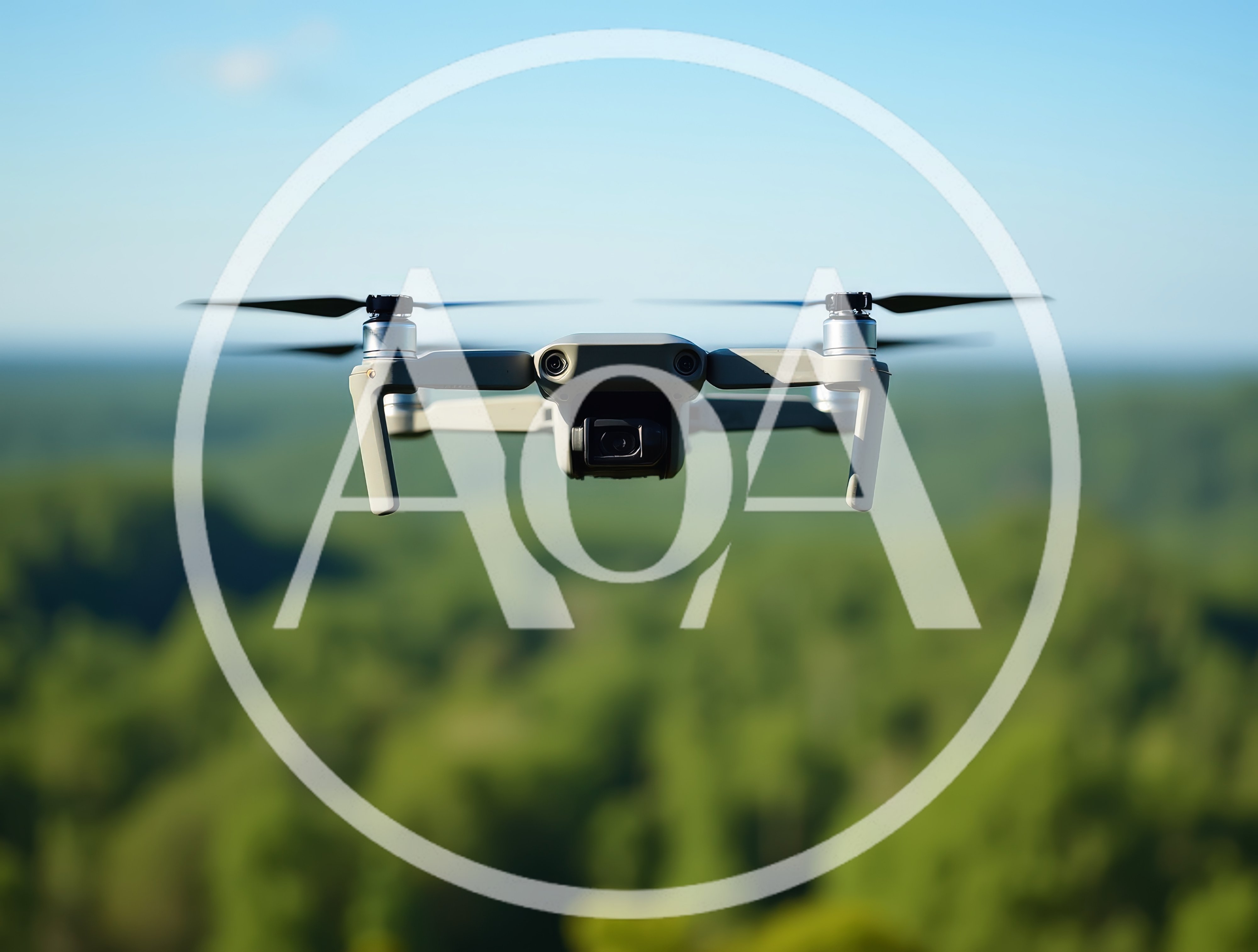 Grey Drone Hovering Over A Lush Green Forest