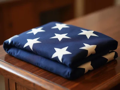 Folded American Flag Resting On A Wooden Table
