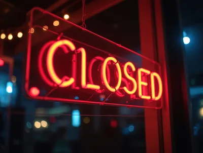Glowing Red Neon Closed Sign In A Window