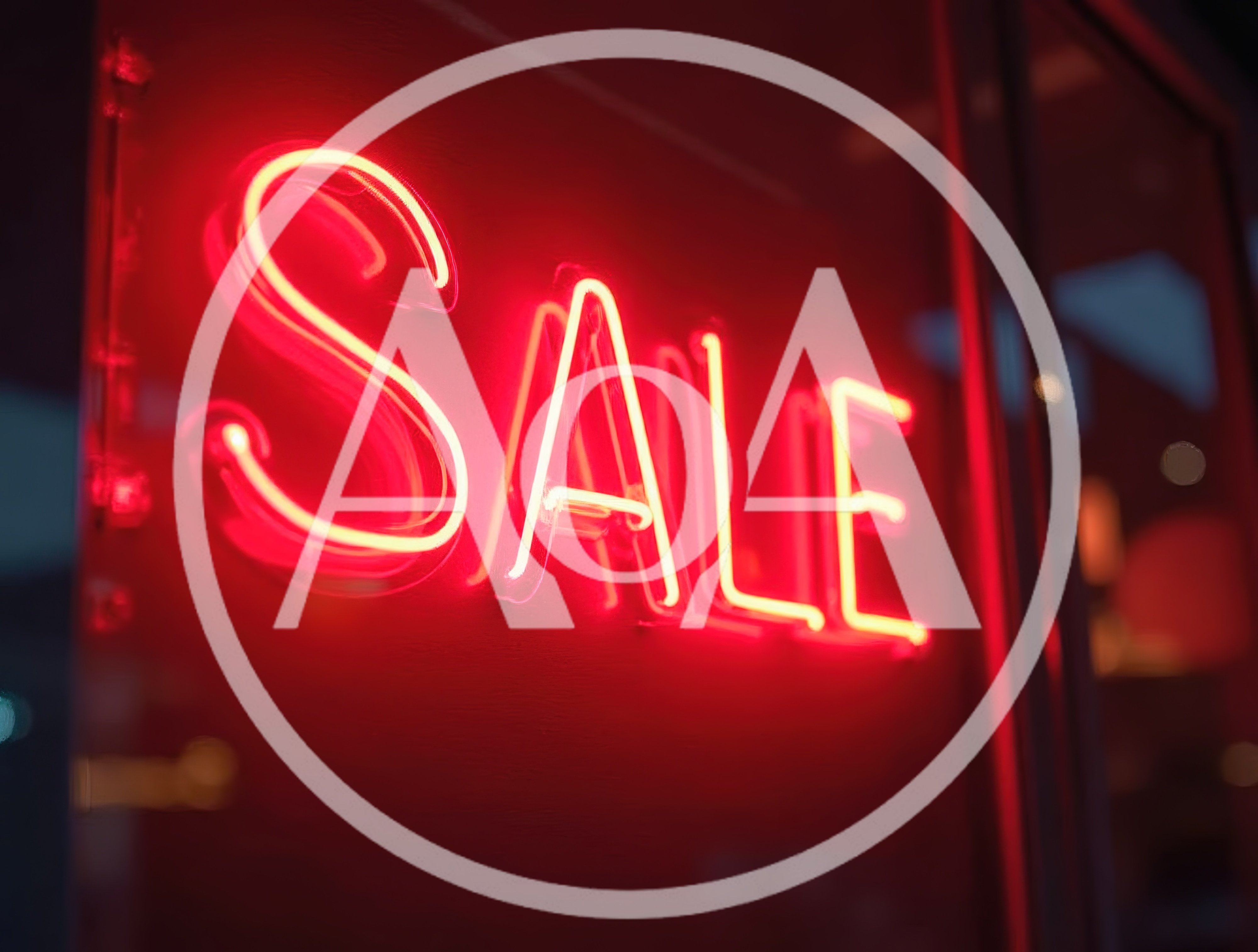 Bright Red Neon Sale Sign In Store Window
