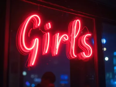 Red Neon Girls Sign Glowing In Night Window