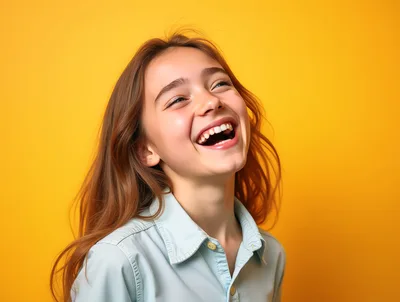 Happy Young Girl Laughing Against Yellow Background
