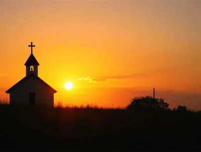 Small Church Silhouette Against A Vibrant Sunset Sky