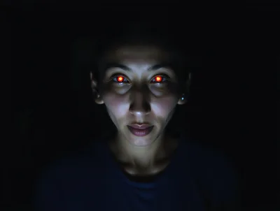 Portrait Of A Woman With Glowing Red Eyes