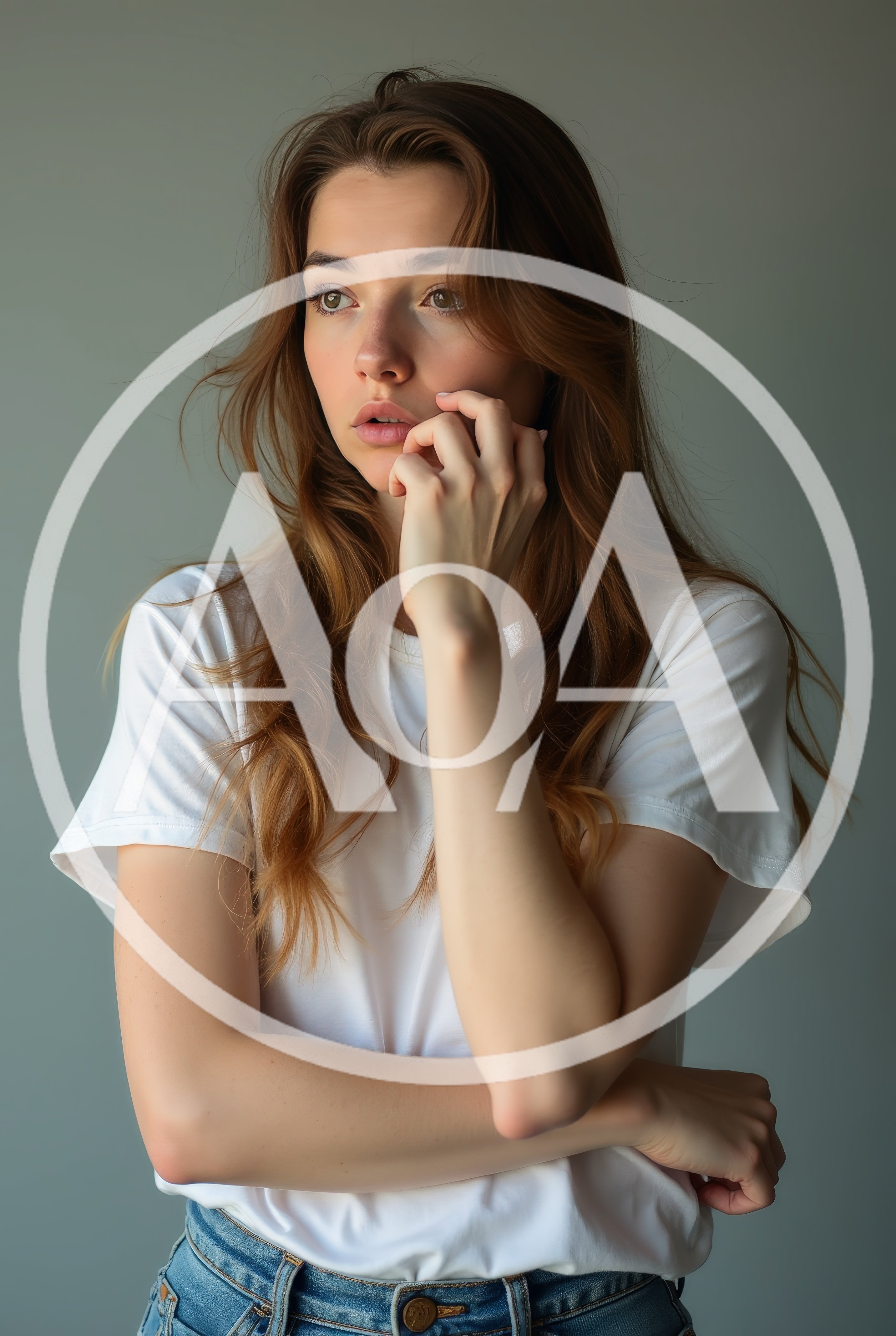 Young Woman Posing Thoughtfully In A White T-Shirt
