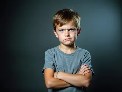 Angry Young Boy With Crossed Arms