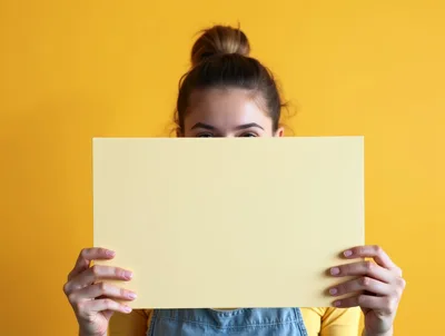 Young Woman Holding Blank Yellow Sign